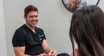 Dentist showing a model of the teeth to a patient